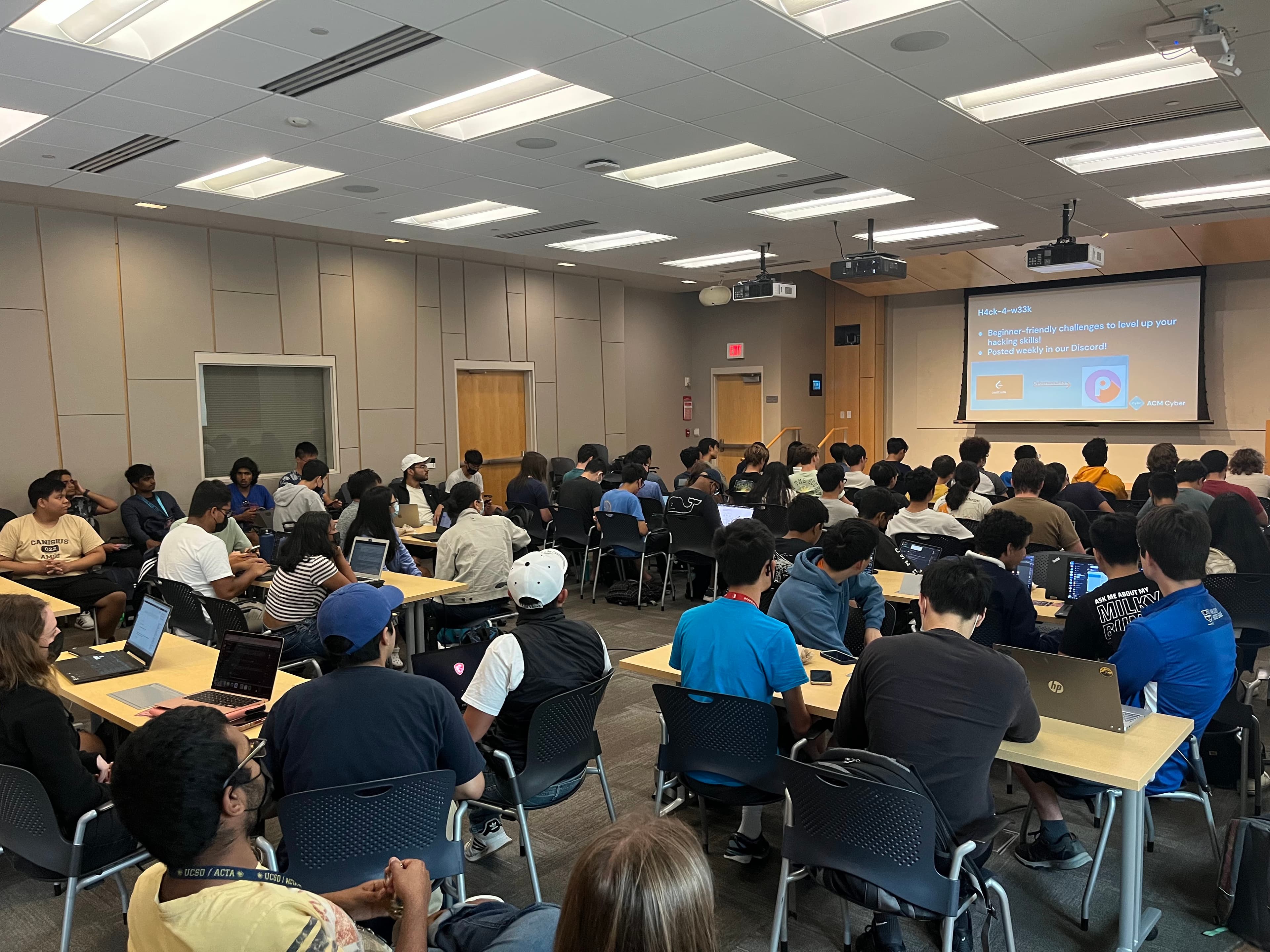 Members lock in on their laptops at an ACM Cyber event