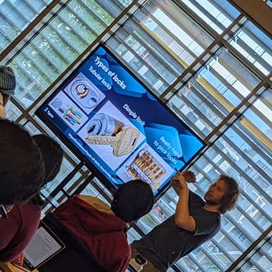 Nick explains types of locks standing next to his presentation