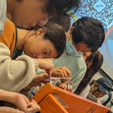 people picking locks on a jig